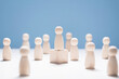 © Brian Jackson - Leadership, wooden business team with one person on podium standing out from the crowd