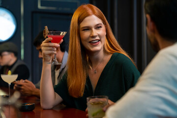 Poster - Group of Cheerful people friends celebrating holiday event hanging out party drinking alcoholic cocktail together at restaurant bar. Man and woman enjoy and fun hangout meeting nightlife at nightclub.