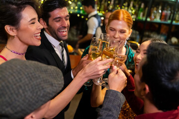 Poster - Group of Cheerful People celebrating holiday event party toasting champagne glass together at luxury restaurant bar. Happy man and woman friends enjoy and fun hangout meeting nightlife at nightclub