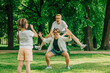 © Westend61 - Daughter photographing playful lesbian couple at park