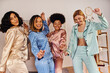© LIGHTFIELD STUDIOS - Cheerful multicultural girlfriends in colorful pajama dancing and having fun together while looking at camera during pajama party at home, slumber party, bonding time in comfortable sleepwear