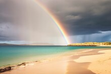 A Breathtaking Rainbow Appears, Stretching Across The Sea And Coastline After The Beach Storm
