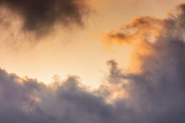 Wall Mural - evening sky in orange glow. huge fluffy clouds. dramatic natural background