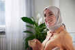 © Johnér - Portrait of smiling woman with hijab having coffee