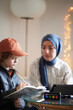 © Johnér - Mother wearing hijab helping son with ADD or ADHD doing homework