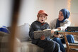 © Johnér - Mother wearing hijab helping son doing homework