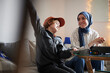 © Johnér - Mother wearing hijab helping son doing homework