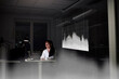 © Johnér - Female finance specialist working in office at night