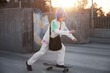 © Johnér - View of girl skateboarding, sunset shining in background