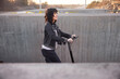 © Johnér - View of young smiling woman riding scooter