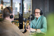 © Johnér - Male radio presenter talking with his guest on radio show or podcast