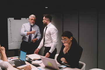 Wall Mural - Businessmen discussing chart during meeting