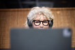 © Johnér - Senior woman with headphones using tablet