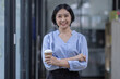 © David - Young asian woman, professional entrepreneur standing in office clothing, smiling and looking confident, workplace office background