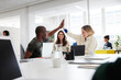 © Johnér - Group of business people high-five during business meeting in office