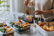 © Johnér - Woman weighing lunch boxes as part of healthy meal prep