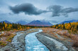 Landscape with mountains, boreal forest in autumn colors and river in the blue hour before sunrise, Yukon territory, Canada