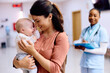 © Drazen - Loving mother with baby daughter at pediatric clinic.