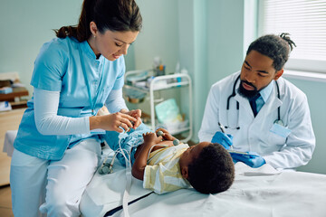 Wall Mural - African American kid during electrocardiogram test at doctor's office.