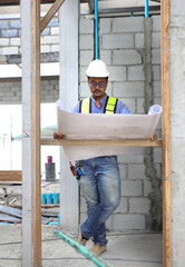 Construction engineers  wear reflection green vest work on site   by following up with the planned design.building contractor check the work against the construction plan.