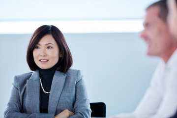 Wall Mural - Smiling businesswoman listening in meeting