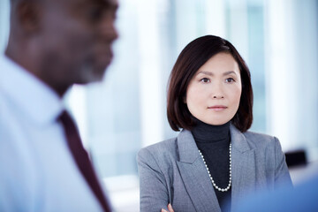 Wall Mural - Serious businesswoman listening in meeting