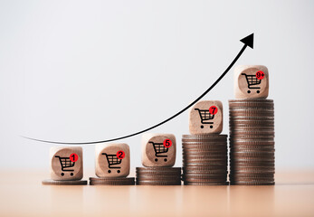 increasing trend graph of sale volume with bigger shopping trolley cart on coins stacking for online