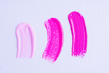 Sticker - Three smears of different pink paint swatch on white paper background. Bright pink, pink and light pink swatch of lip gloss, cosmetic product stroke or paint