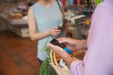 Poster - Grocery store clerk using credit card machine