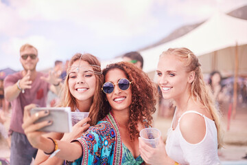 Wall Mural - Young women posing for selfie at music festival