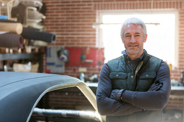 Wall Mural - Portrait confident mechanic in auto repair shop