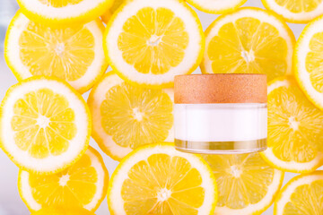 Citrus fruit glass jar of cream moisturizer and orange lemon slices background. Flat lay, top view. skin care routine with hyaluronic acid and collagen.