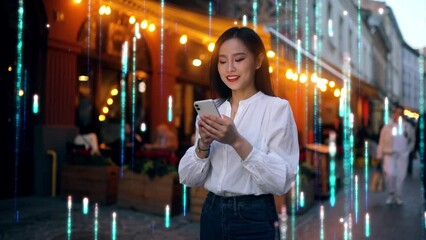 Wall Mural - Beautiful Smiling Asian Woman Using Smartphone on a City Street at Night. Visualization of the Internet by information lines flying to the global digital network. Wireless communication