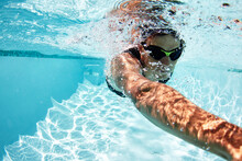 Male Swimmer Athlete Swimming Underwater In Swimming Pool