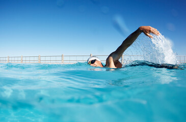 Canvas Print - Male swimmer athlete swimming in sunny swimming pool