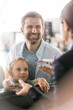 © KOTO - Father and daughter with airplane tickets at airport check-in counter