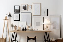 Table With Empty Picture Frames Close To A Light Wall. Generative AI