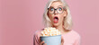 Blond girl watching tv or movie in cinema holding bowl of popcorn with shocked expression. Image generative AI.