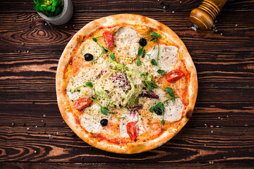 Wall Mural - Pizza with cheese, chicken fillet, tomatoes, olives, lettuce and microgreens.