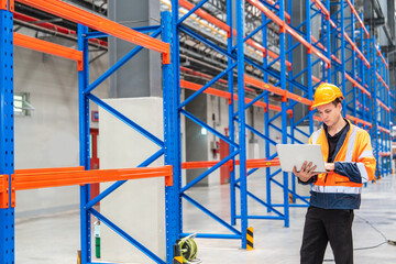 Engineers wearing reflective jackets and helmets for safety walk to inspect the construction of steel floors in a warehouse using a distribution center.