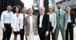 © carlesiturbe - Laughing group of multiethnic businessman and businesswoman staring at camera outside. Multiracial happy and confident executive team standing in the street.
