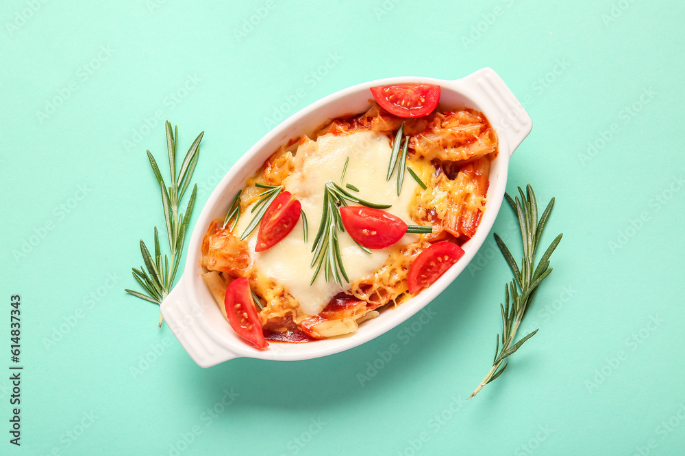 Baking dish of pasta with tomato sauce and cheese on blue background