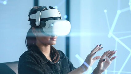 Women wearing VR goggles posing finger pointing and touching on the air connecting to internet metaverse system with holographic screen. Digital technology of the future. Virtual reality concept