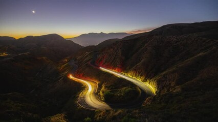 Wall Mural - night time lapse of traffic on a road winding through the mountains near los angeles.