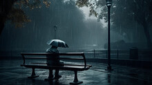 An Image Of Depression Showing A Man Sitting On An Abandoned Bench In A Rainy Park.