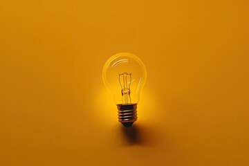 bright light bulb on a vibrant yellow background