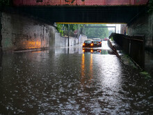 Two Cars Stranded In Flood Water Under Low Bridge In Salford City Street Flashing Emergency Lights.