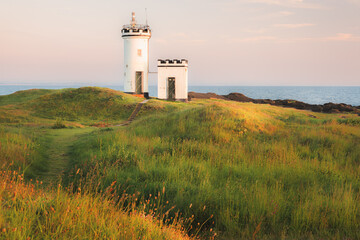 Wall Mural - Scenic seascape landscape at sunset or sunrise of Elie Ness Lighthouse on the East Neuk Peninsula in coastal Fife, Scotland, UK.