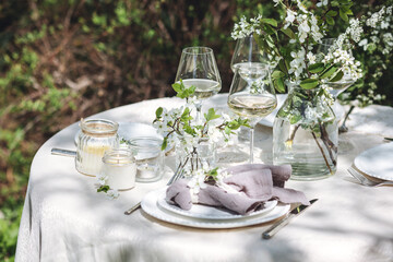 rustic zero waste wedding decor with natural elements. fresh spring blooming flowers, candles, linen