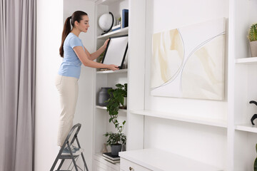 Sticker - Woman on ladder with picture near shelves at home